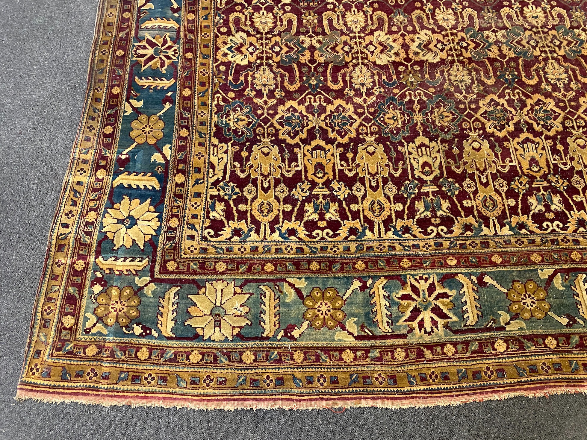 A large Sarouk purple ground carpet, approx. 20ft x 12ft. (cut in one area)